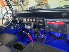 the interior of a car with blue lighting