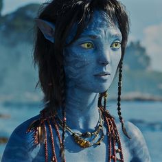 a woman with blue skin and yellow eyes