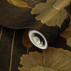 an artistic wallpaper with gold leaves and a white object in the center on top