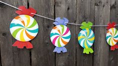 colorful paper cutouts are hanging on a line with lollipops in the shape of turtles