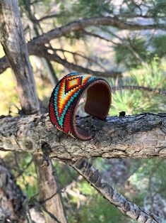 Bracelet length - 6" width 11/4" Material - Aluminum Base - Faux Leather with Pretty seed beads work sewn onto aluminum base. Adjustable Adjustable Hand-stitched Cuff Bracelet, Artisan Hand-stitched Adjustable Jewelry, Adjustable Cuff Bracelet With Colorful Beads, Unique Hand-stitched Adjustable Jewelry, Hand-stitched Adjustable Bohemian Jewelry, Unique Adjustable Hand-stitched Jewelry, Handmade Cuff Bracelet As Fashion Accessory, Bohemian Cuff Bracelet With Large Beads, Southwestern Cuff Bracelet With Round Beads