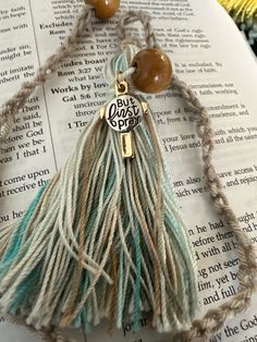 a tasseled bookmark on top of an open bible