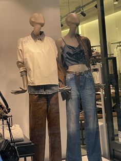 two mannequins dressed in jeans and shirts