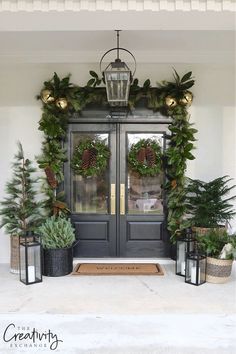 front door decorated for christmas with evergreen wreaths and pine cones