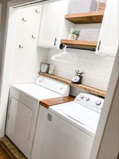 a white washer and dryer in a small room