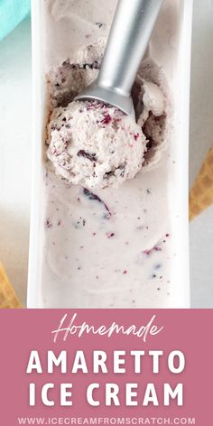 homemade amarettoo ice cream in a white container with an ice cream scooper