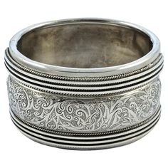 Beautiful Victorian heavy silver bangle, with a lovely engraved raised central panel, and a rope twist and line design to either side. The back has a silky silver sheen. The bracelet tests for silver. It is slightly oval, the inside measurements are 5.7cm / 2.24 inches by 4.9cm / 1.9 inches, and the width is 3.7cm / 1.45 inches. The bracelet is in very good condition, with scratching and some minor indentations as expected. The clasp works well. This is a fabulous heavy antique bangle in a very Luxury Hallmarked Antique Silver Bracelet, Luxury Victorian Etched Bracelets, Luxury Hallmarked Victorian Sterling Silver Bracelet, Etched Silver Bands For Formal Occasions, Antique Engraved Silver Cuff Bracelet, Victorian Style Silver Engraved Bangle, Victorian Silver Engraved Bangle, Victorian Style Engraved Silver Bangle, Silver Engraved Wide Band Bangle