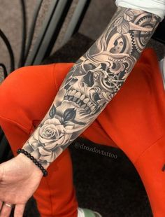 a person sitting down with a tattoo on their arm