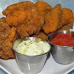 fried chicken and dipping sauces on a white plate