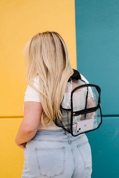 The Jenna Clear Backpack is the perfect choice for both kids and adults thanks to its versatile size and adjustable backpack straps. Featuring a fully-transparent design and front pocket for convenient storage, this clear bag is perfect for school, concerts, or other activities that require security checks. Enjoy all the benefits of a sturdy and secure backpack with peace of mind! Details: 11" long x 11.5" height x 6" wide Mesh side pocket fits up to 16 oz. water bottle Silver hardware 2 exterio Clear Backpack, Pom Pom Keychain, Clear Bag, Clear Bags, Transparent Design, Backpack Straps, Boutique Brands, Timeless Accessories, Modern Chic