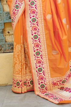 This Saree is Ready to Wear (With Fall and Pico Done). A designer saree in Orange with an intricate Golden border. It has intricate design all over the saree. This saree is a suitable amalgamation of style and grace that is required from an ethnic wear. The saree is ideal for any formal gathering. The saree comes with an unstitched blouse of corresponding color and design as shown in the picture. Traditional Orange Banarasi Silk Pre-draped Saree, Traditional Orange Pre-draped Saree With Zari Weaving, Festive Orange Pre-draped Saree With Zari Weaving, Orange Banarasi Silk Pre-draped Saree For Diwali, Anarkali Traditional Wear With Paithani Silk Border, Orange Art Silk Pre-draped Saree With Zari Weaving, Orange Saree With Zari Weaving, Orange Pre-draped Art Silk Saree With Zari Weaving, Orange Saree With Zari Weaving Traditional Drape