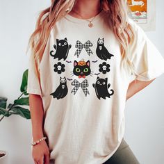 Halloween Black Cat & Ghost Comfort Colors® Shirt, Halloween Ghost Tshirt, Spooky Season Cat Tee, Halloween Cute Women Outfit, Cat Shirt Experience ultimate comfort with our unisex Comfort Colors® t-shirt, crafted from 100% ring-spun cotton! This relaxed-fit tee is perfect for casual days, offering a soft, worn-in feel right out of the package. Perfect for any occasion, this versatile tee is designed to keep you looking and feeling great, whether you're out and about or relaxing at home. ⭕𝐏𝐫𝐨𝐝𝐮𝐜𝐭 𝐅𝐞𝐚𝐭𝐮𝐫𝐞𝐬⭕ ✅Material: 100% ring-spun U.S. cotton for a soft, comfortable feel. ✅Fit: Relaxed fit for a casual, comfortable look. ✅Sizes: Available in six sizes, from S to 3XL. ✅Colors: Choose from 11 stylish colors to suit your style. ✅Pre-Shrunk: Designed to maintain its size and sh Black Cat Ghost, Ghost Tshirt, Cat Ghost, Halloween Black Cat, Halloween Cute, Ghost Cat, Ghost Shirt, Cat Tee, Comfort Colors Shirt