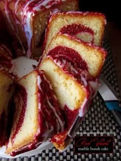 a cake with red and white icing sitting on top of a table