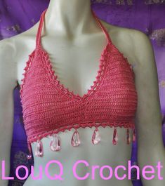 This hand crocheted top is made from 100% cotton with a shimmery glitter look, bordered with small pink beads and large crystal like drop beads around the bottom. The top ties at neck and back bikini style for adjustable sizing depending on how you like to wear it. Completely waterproof to swim in, casual or chic dress up. Pink Triangle Crochet Top For The Beach, Pink Triangle Crochet Top For Beach, Pink Halter Neck Crochet Top For Beach, Pink Triangle Top Crop Top For Vacation, Summer Party Pink Crochet Top, Pink Crochet Beachwear Top For Festival, Pink Beachwear Crochet Top For Festival, Bohemian Pink Triangle Halter Top, Pink Halter Neck Crop Top For Beach Season