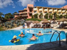 people are in the swimming pool at an outdoor resort