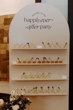 there are many desserts on the shelves in this display case that says happily after party