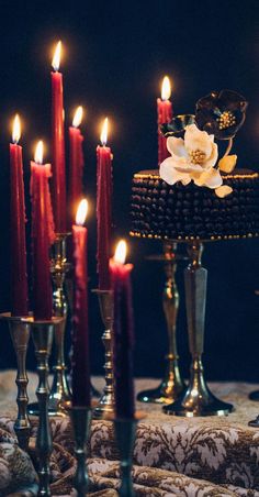 a table topped with lots of lit candles