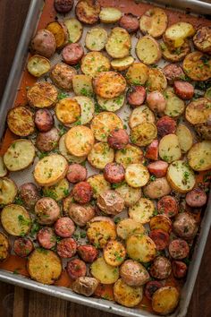 a pan filled with cooked potatoes on top of a wooden table