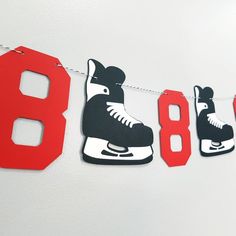 an ice skate themed birthday banner hanging on a line with roller skates and number 8