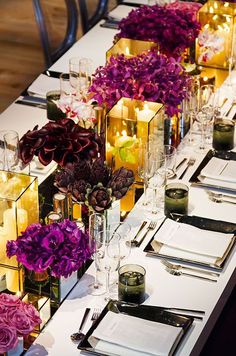 a long table with candles and flowers on it