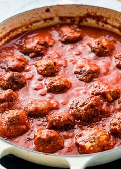 meatballs and tomato sauce in a pan on the stove