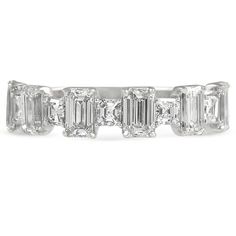 a white gold ring with five emerald cut diamonds