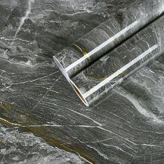 a marbled surface with two metal tubes sticking out of it