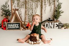 a baby sitting on the floor eating cake