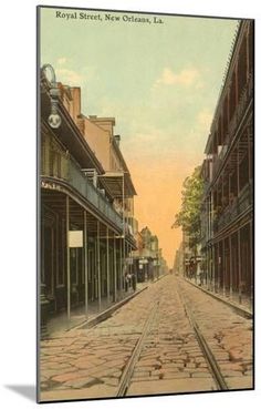 an old time photo of a street in new orleans, la with railroad tracks running through it