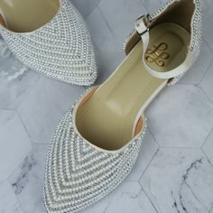 Elevate your style effortlessly with these stunning pearl-embellished flats, designed for the modern woman who values both elegance and comfort. Crafted with meticulous attention to detail, these flats feature a luxurious array of pearls and metallic beads, creating a delicate and sophisticated texture that catches the light with every step. The pointed toe and ankle strap add a touch of femininity and provide a secure, comfortable fit, making these flats perfect for all-day wear. Key Features: Elegant White Pointed Toe Flats For Wedding, White Closed Toe Pointed Flats For Party, White Closed Toe Flats For Party, Elegant Pointed Toe Flats With Ankle Strap For Wedding, Elegant Wedding Pointed Toe Flats With Ankle Strap, White Low Heel Ballet Flats For Party, Elegant Embellished Ballet Flats For Party, Flat Wedding Shoes With Rhinestones, Elegant Wedding Flats With Rhinestones