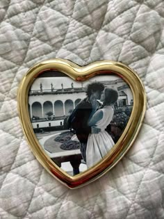 a heart shaped frame with a couple kissing in it