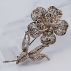 This vintage sterling flower brooch features gorgeous, elaborate filigree wire work making up the petals of the flower and the leaves. This brooch weighs 5.4 grams and measures 48mm wide. This piece is in great vintage condition with light wear and is not marked but has been tested and is guaranteed. Formal Filigree Flower Brooches, Ornate Flower Brooch With Filigree, Vintage Filigree Flower Brooches, Work Makeup, Wire Work, Flower Brooch, Brooch Pin, Brooches, Flowers