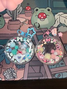 two key chains with charms attached to them