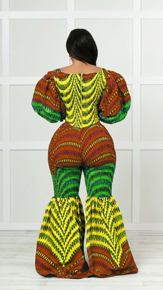 Make a bold fashion statement in this African print jumpsuit. The bell-bottom silhouette is a stylish way to show off your curves and add a touch of flair to any look. Crafted from a soft and stretchy material, this jumpsuit is perfect for any occasion. The vivid pattern features tribal style designs that add a unique and stylish touch to the look. Wear this vibrant piece with a pair of heels, and have an outfit that looks great all day long. This jumpsuit is made of 100% African cotton and is e Fitted Multicolor Maxi Length Sets, Multicolor Printed Stretch Jumpsuits And Rompers, Multicolor Stretch Printed Jumpsuits And Rompers, Stretch Multicolor Printed Jumpsuits And Rompers, Fitted Printed Jumpsuits And Rompers, Green Fitted Wide-leg Jumpsuits And Rompers, Fitted Multicolor Printed Jumpsuits And Rompers, Multicolor Printed Maxi-length Jumpsuits And Rompers, Chic Fitted Multicolor Jumpsuits And Rompers