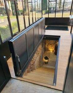 an open door leading to a room with glass walls