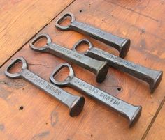 four old rusty wrenches sitting on top of a wooden table