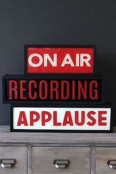 there are two signs that say on air and recording applause next to each other