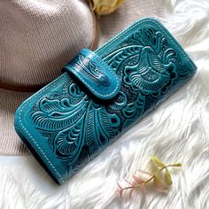 "Timeless women wallets first used in the 60's and 70's as an evolution for women accessories. For a better future , we are a sustainable and ethically sourced leather shop. Labor time: 6-7 hours We have laser engraving available just add the engraving listing to your order. (Engraving has a additional charge) All handcrafted one at a time by master leather artisans - 9 credit card slots - One zipper coin pocket - ID Window - Two bill compartments - Metal magnetic clasp - 7\" L x 3.5\" W (18 x 9 Embossed Rectangular Wallets For Gifts, Hand Tooled Rectangular Wallet For Gift, Hand Tooled Rectangular Wallet As Gift, Boho Wallet, Womens Wallets, Engraved Wallet, Women's Wallets, Teal Leather, Handmade Wallets