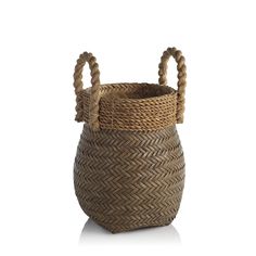 a woven basket with two handles on the front and one handle at the back, sitting on a white surface