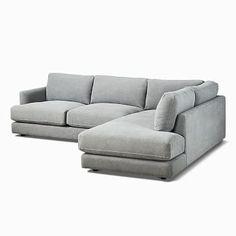 a large gray couch sitting on top of a white floor