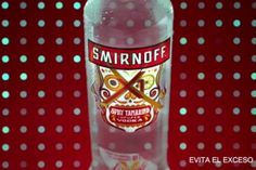 a bottle of smirnoff vodka on a red background with white polka dots