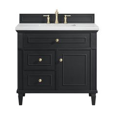 a black bathroom vanity with white counter top and two faucets on the sink