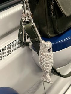 an owl keychain hanging from the side of a car