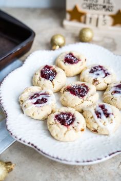 cookies with jam are on a white plate