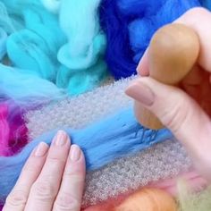 a person is making something with colored yarn