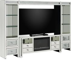 a white entertainment center with drawers and a flat screen tv mounted on it's side