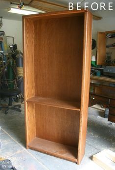 a wooden bookcase sitting inside of a garage