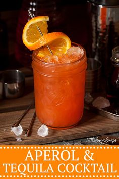 an orange drink in a mason jar with a toothpick sticking out of it