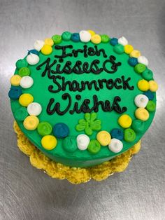 a green frosted cake that says irish kisses, shamrock wishes