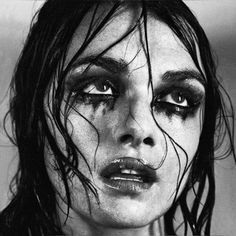 a black and white photo of a woman with wet hair